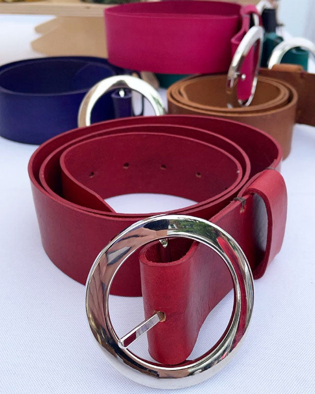 Beautiful hand-crafted 100% genuine leather belts. hand-dyed with bright dyes, colors include, pink, purple, turquoise, black , tan, blue, orange, reed with custom made Odell belt buckles in nickel plated brass.